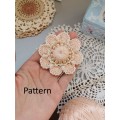 Crochet flower with pearls.